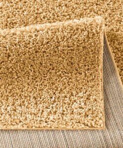 Hoogpolig vloerkleed effen Spectrum - mosterdgeel - close up vouw, thumbnail