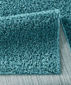 Hoogpolig vloerkleed effen Spectrum - turquoise - close up vouw, thumbnail Hoogpolig vloerkleed effen Spectrum - turquoise - close up vouw, thumbnail