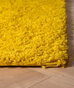 Hoogpolig vloerkleed shaggy Trend effen - geel - close up hoek
